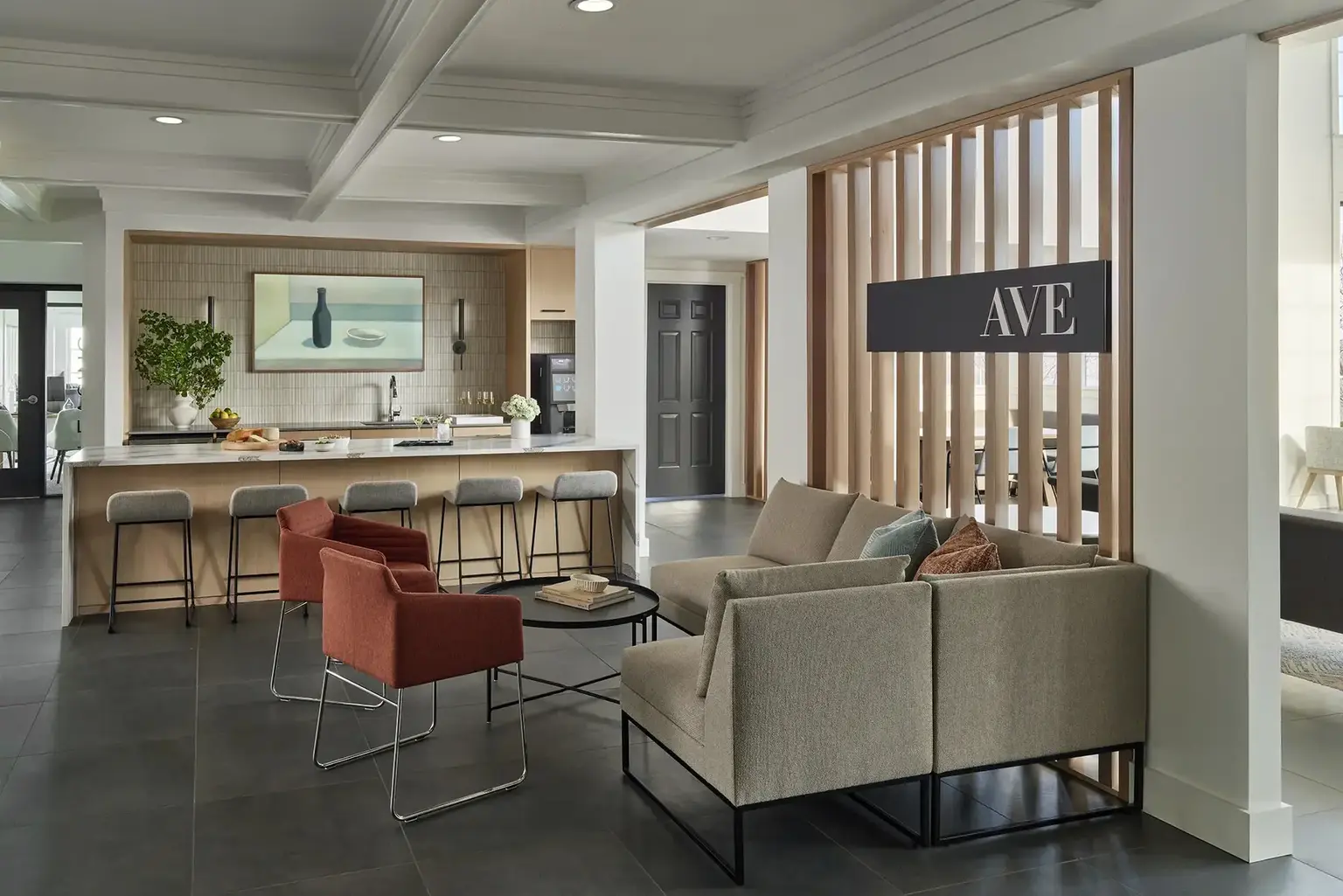 AVE Malvern lounge with a guest bar and a large AVE sign on the wall