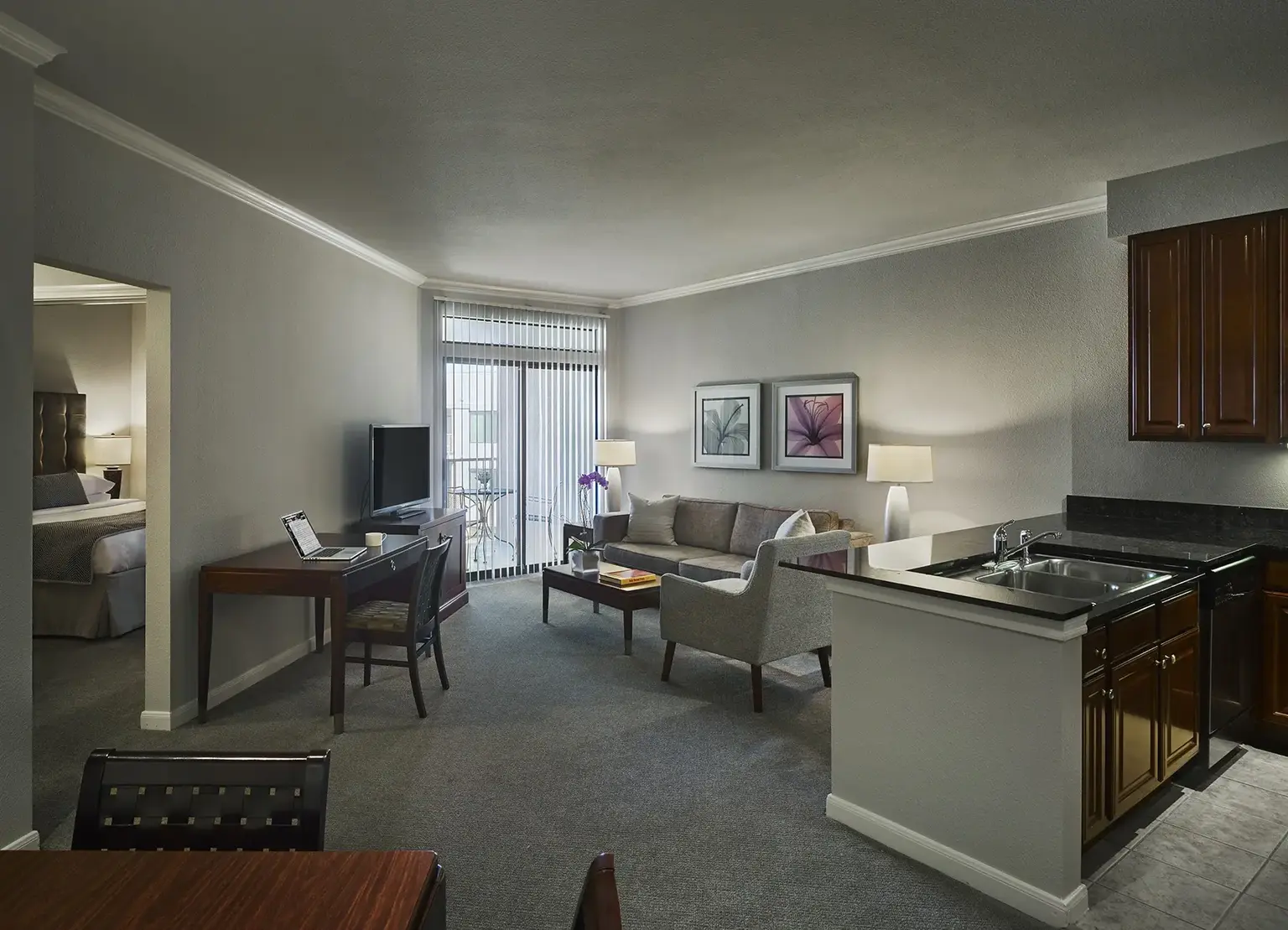 AVE Clifton furnished apartment living room with gray couch and open kitchen access