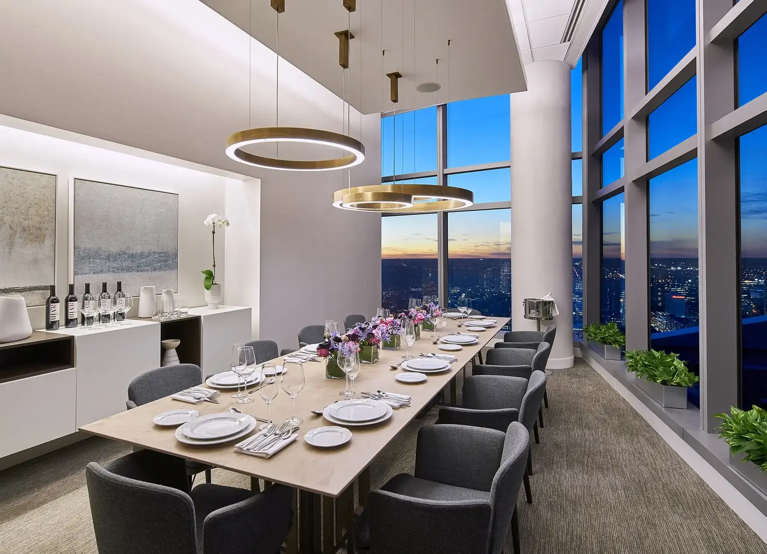 AKA University City meeting room with large table set up for a formal dinner with Philadelphia city views at sunset 