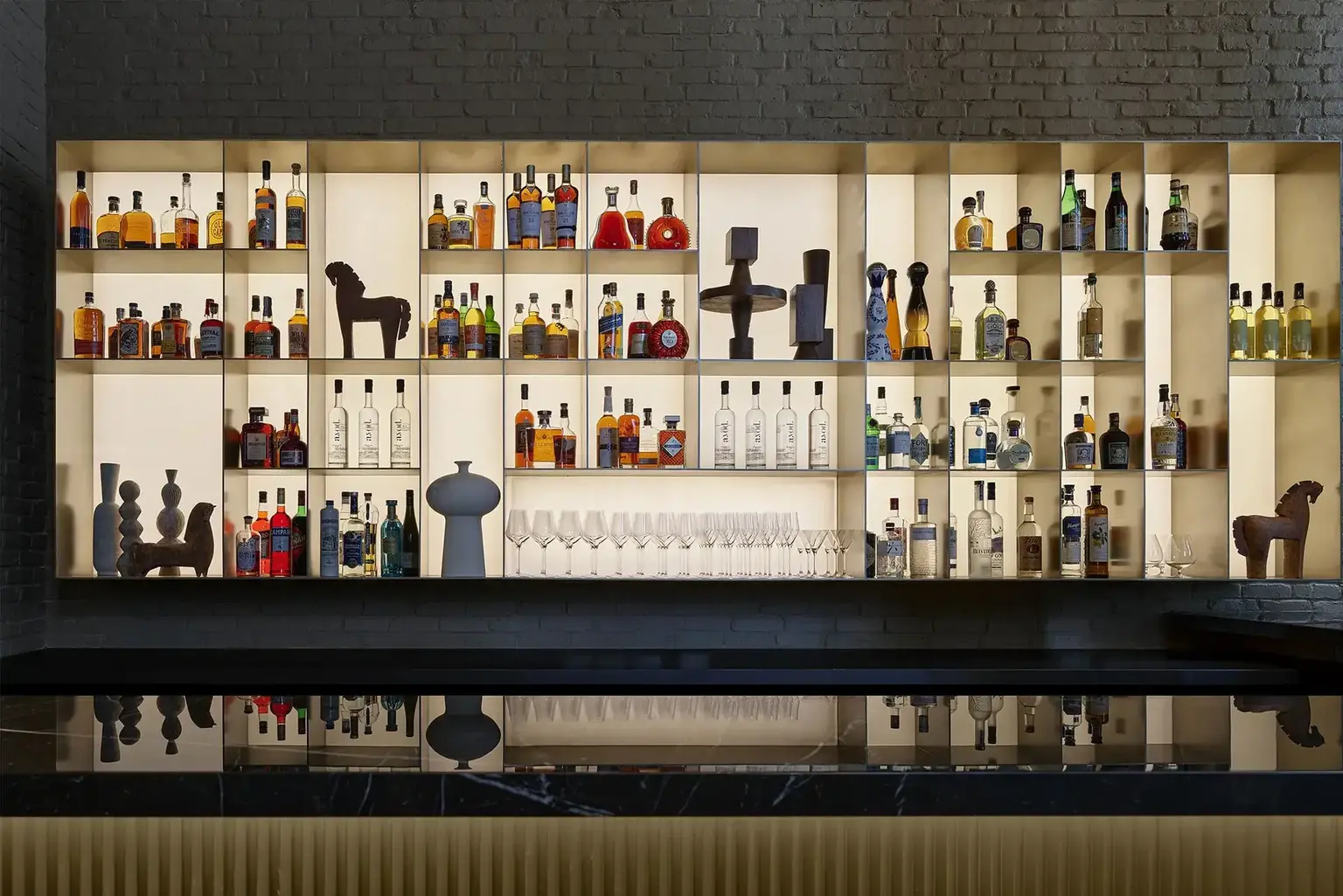 Hotel AKA NoMad back-lit liquor bar wall with bottles