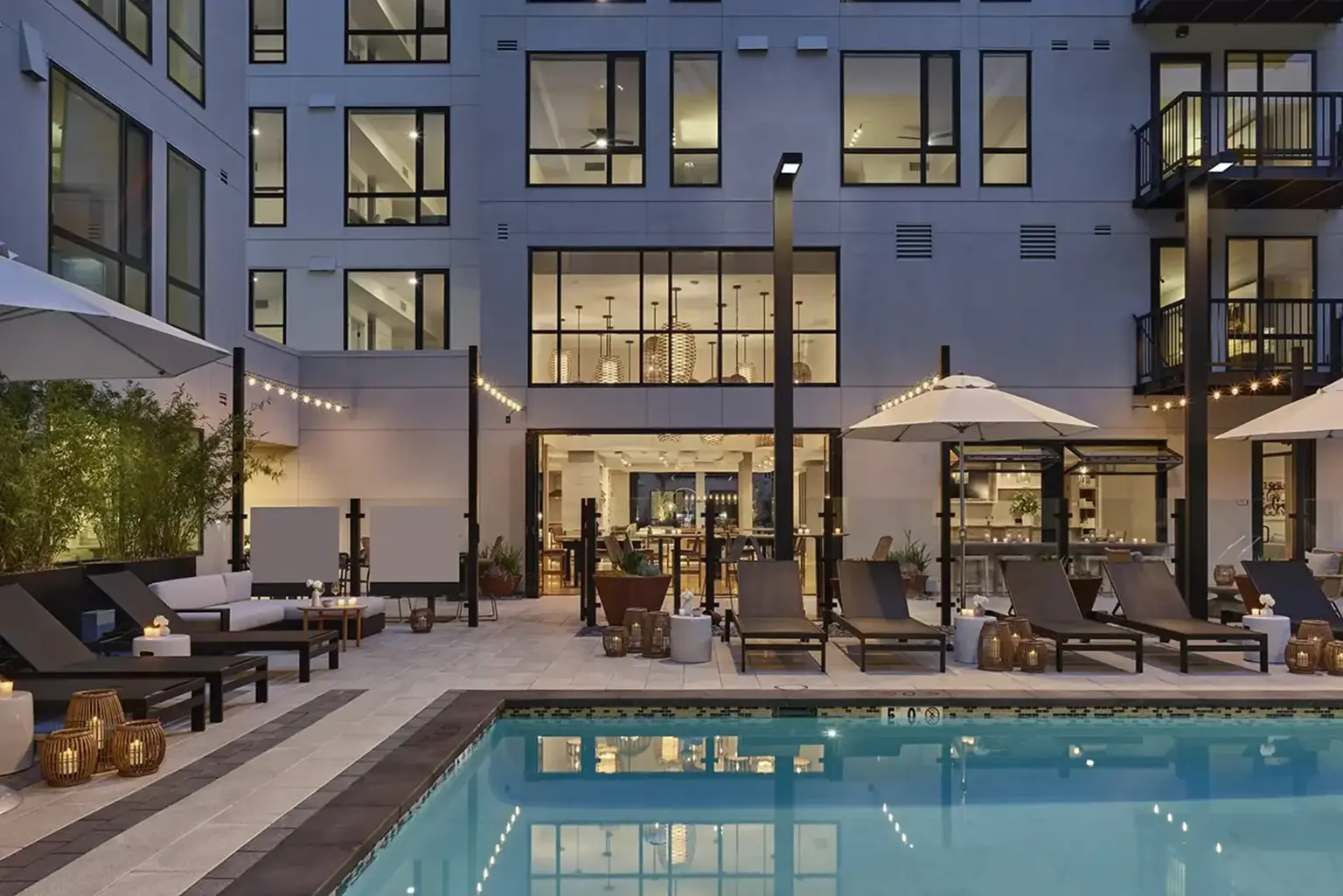 Dusk view of the AVE Santa Clara Pool on the inner court of the apartment building