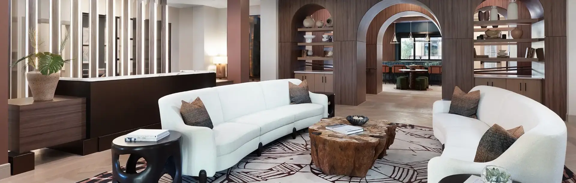 AVE Paradise Valley lounge with white sofas and dark wooden panels
