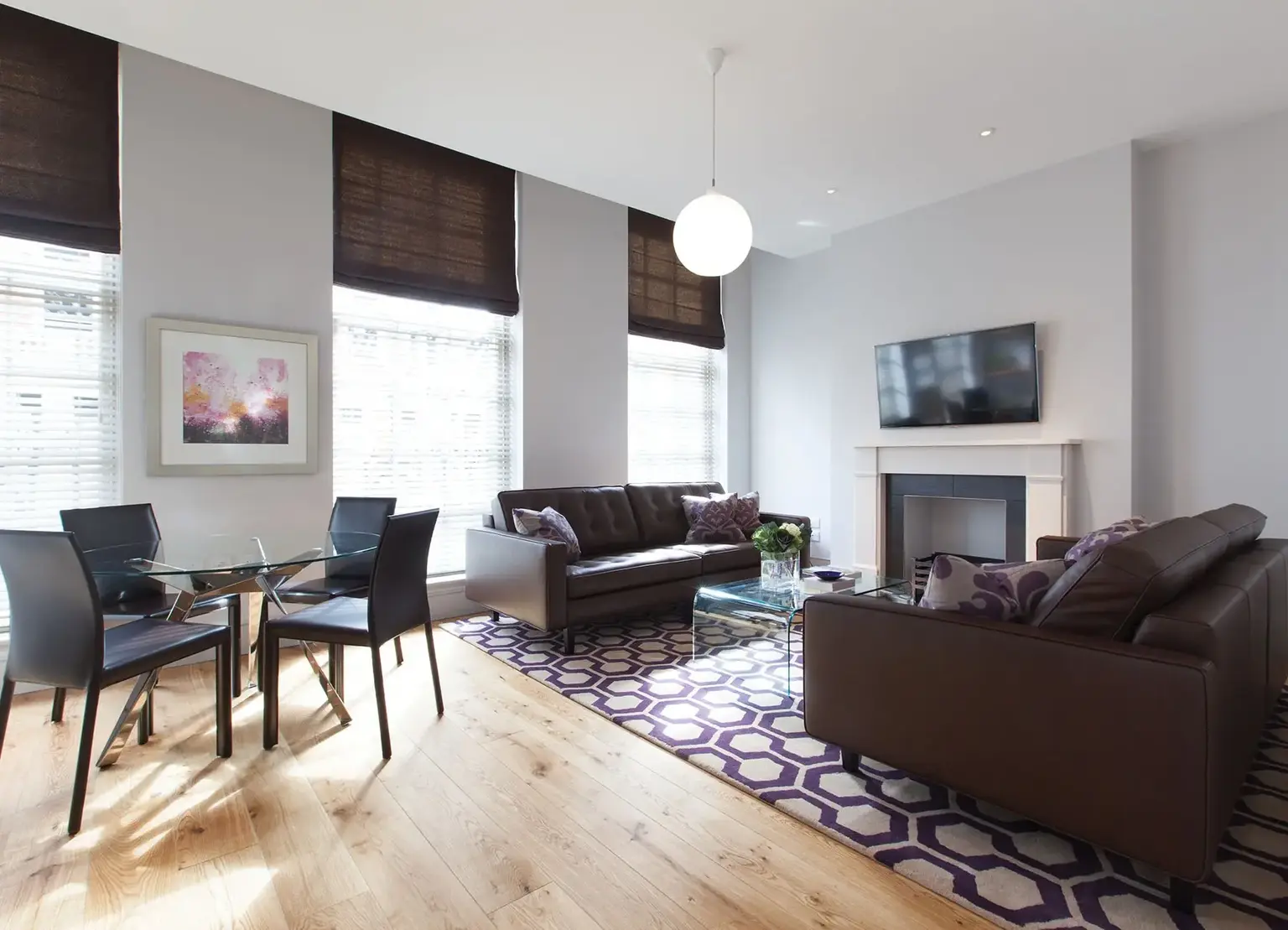AKA Marylebone furnished apartment living room with leather couches and purple rug