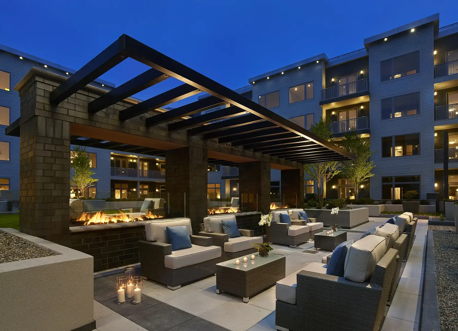 AVE Florham Park apartment courtyard with green space, chairs, and firepit