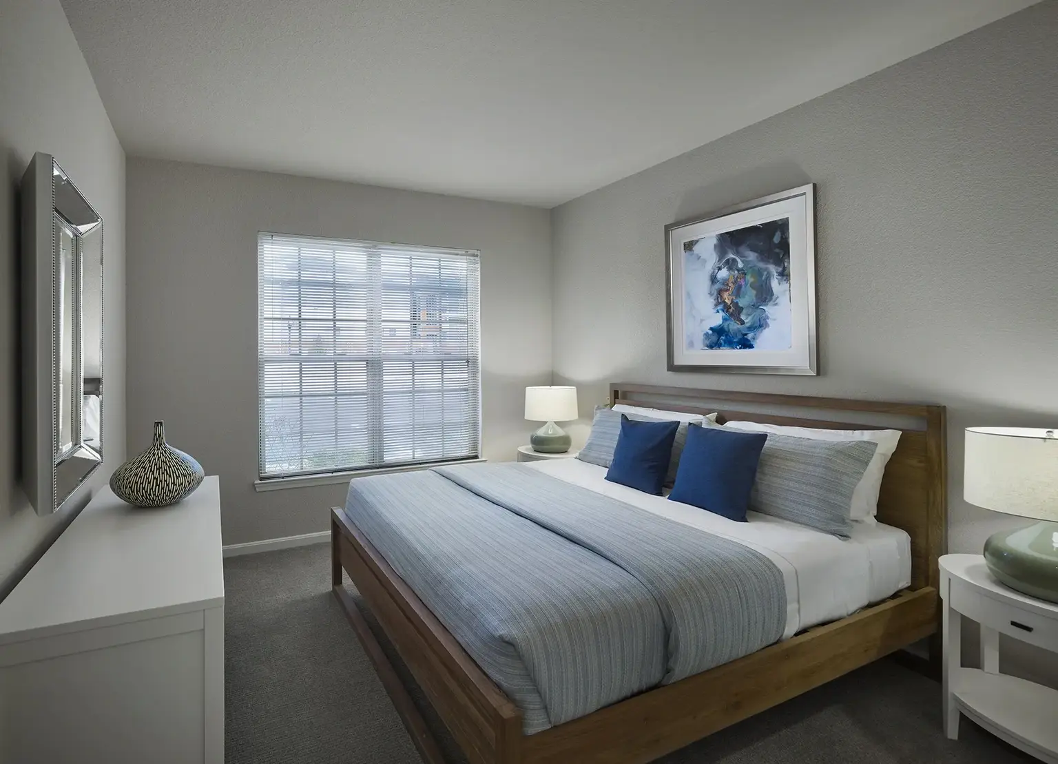 AVE Somerset furnished apartment bedroom with blue sheets and a television