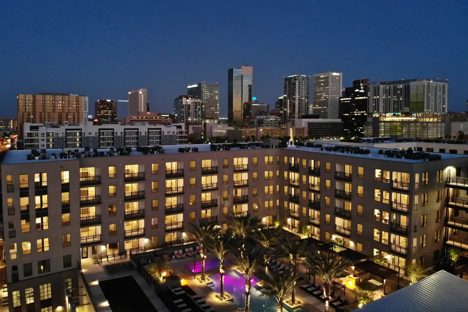 AVE Phoenix Terra exterior showing seven-story building with flower-lined walkway