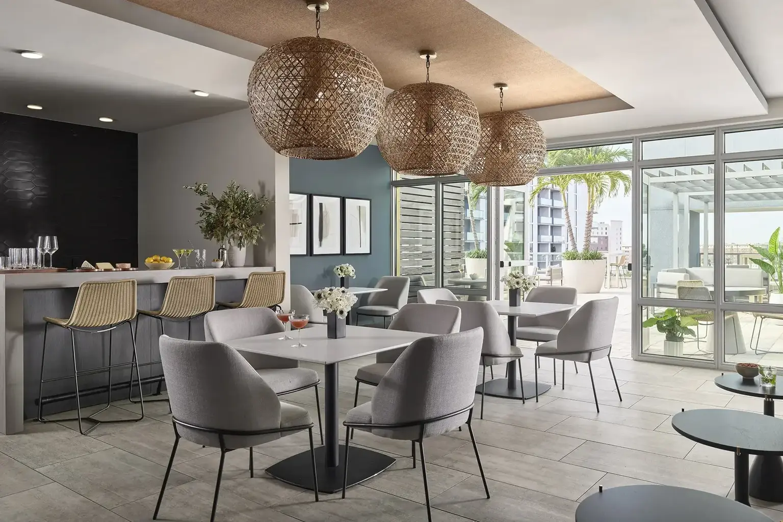 AVE Tampa Riverwalk Lounge with tables, chairs and a bar with a view of inner court 