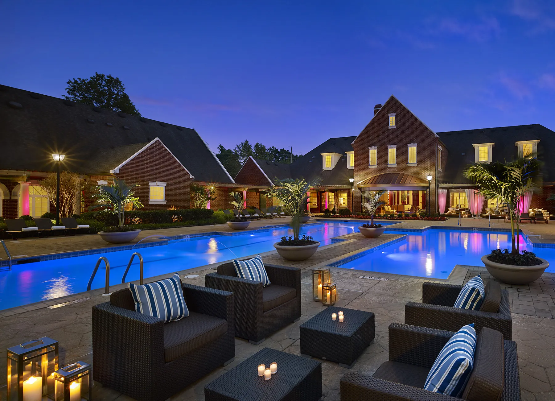 AVE Somerset apartment building at night with pool, lights and candles