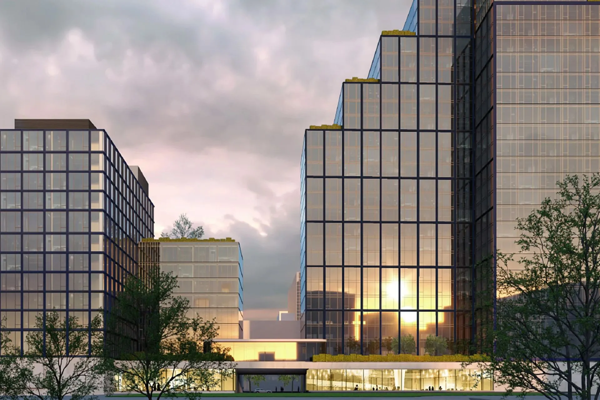 AVE Hamilton Green new building front with reflective windows at dusk